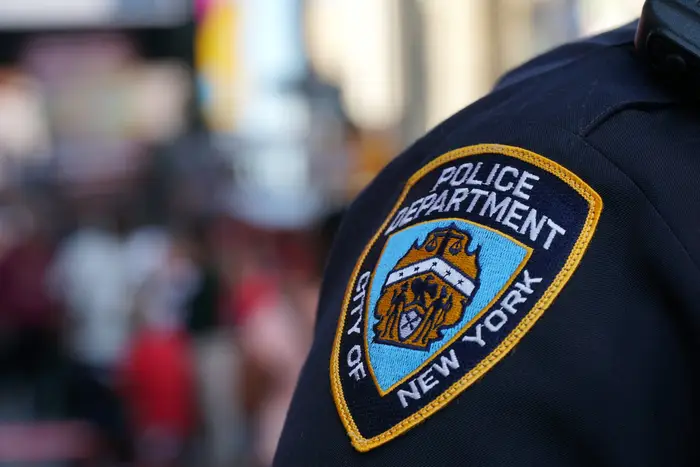 An NYPD patch on an officer's shoulder.